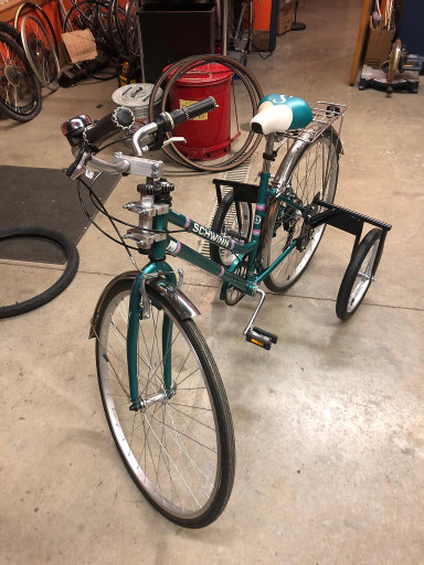 cyan bike with training wheels