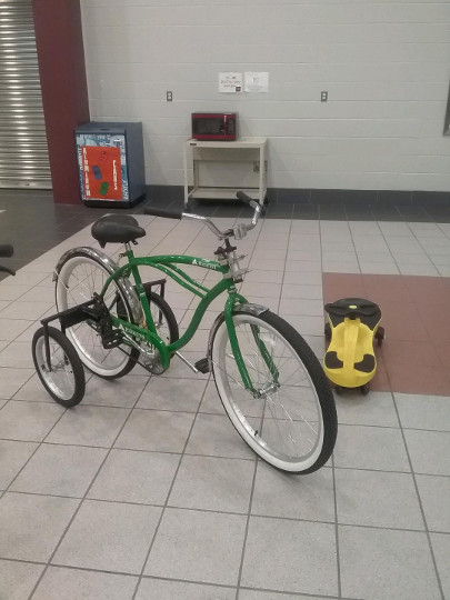 green bike with training wheels